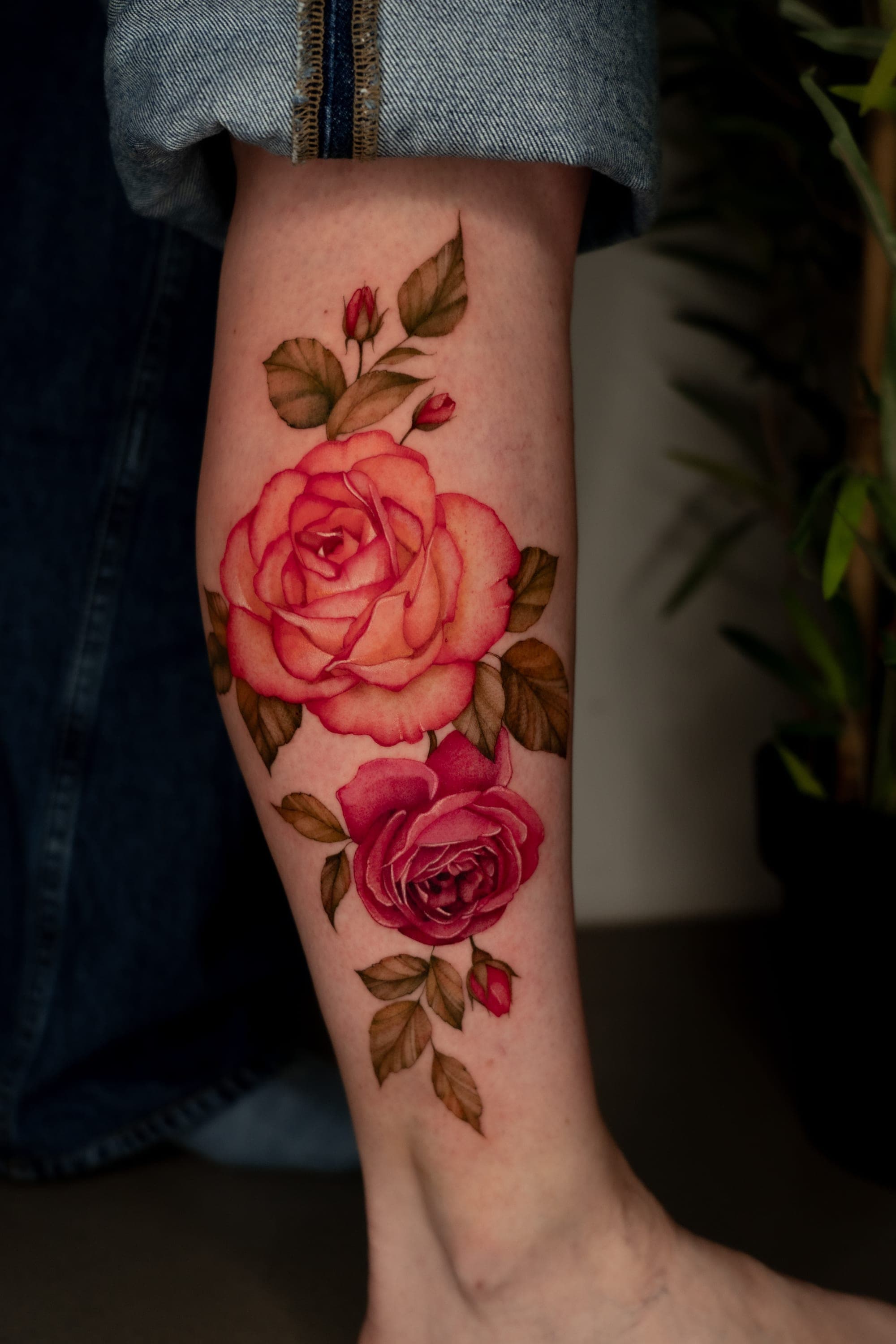 Coral and red rose tattoo on calf