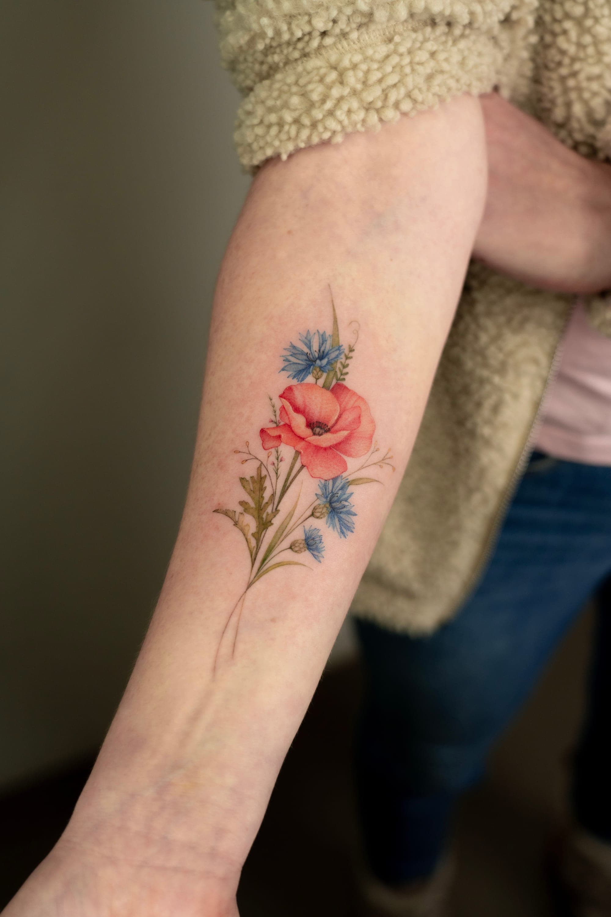 Poppy and cornflower minimalist forearm tattoo