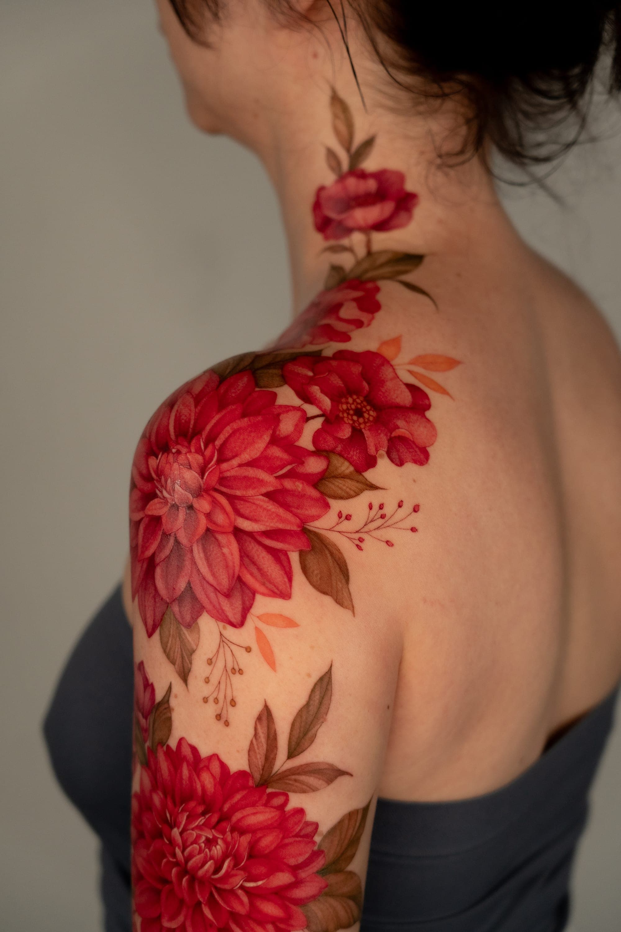 Red dahlia flower sleeve tattoo