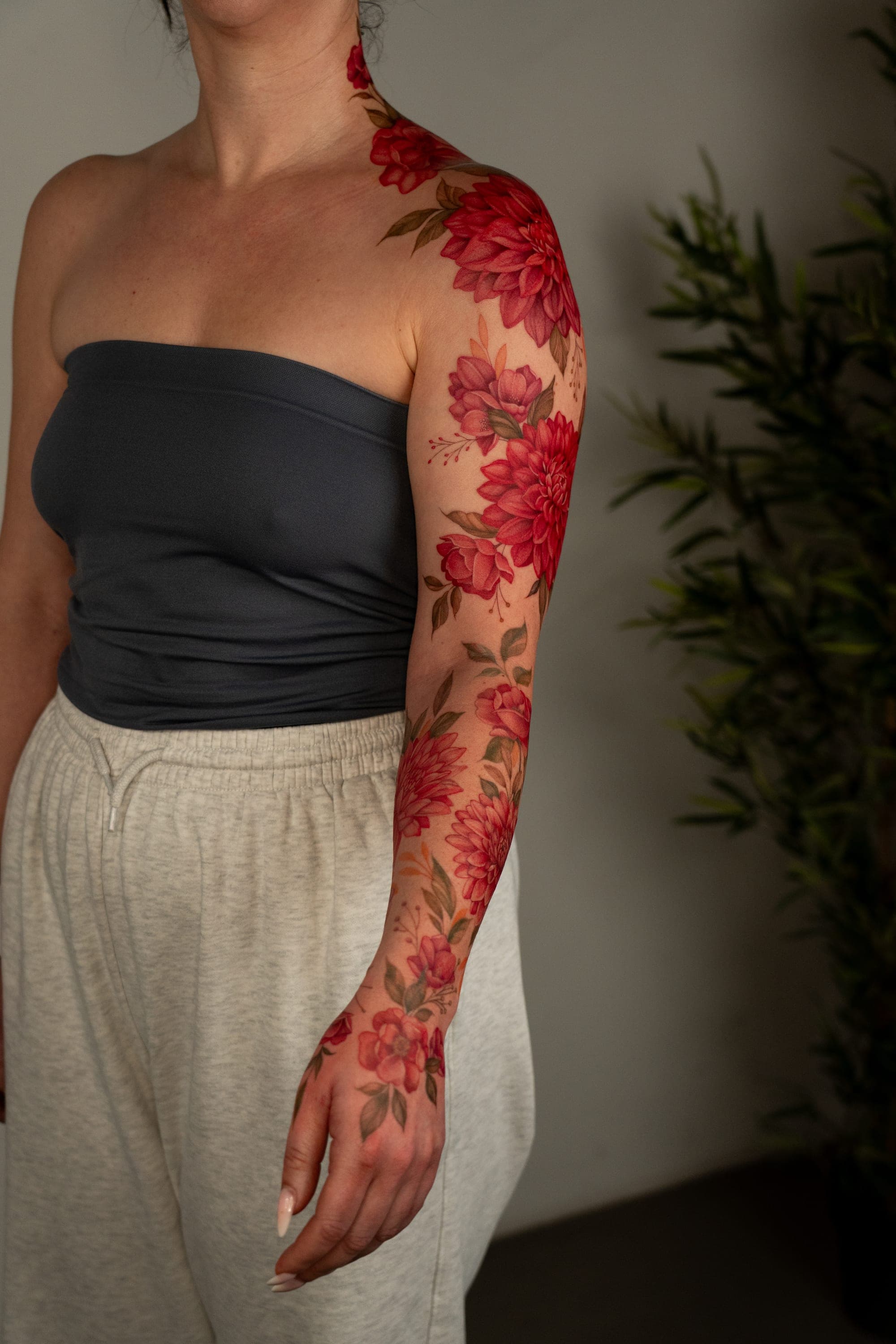 Red dahlia shoulder and neck tattoo