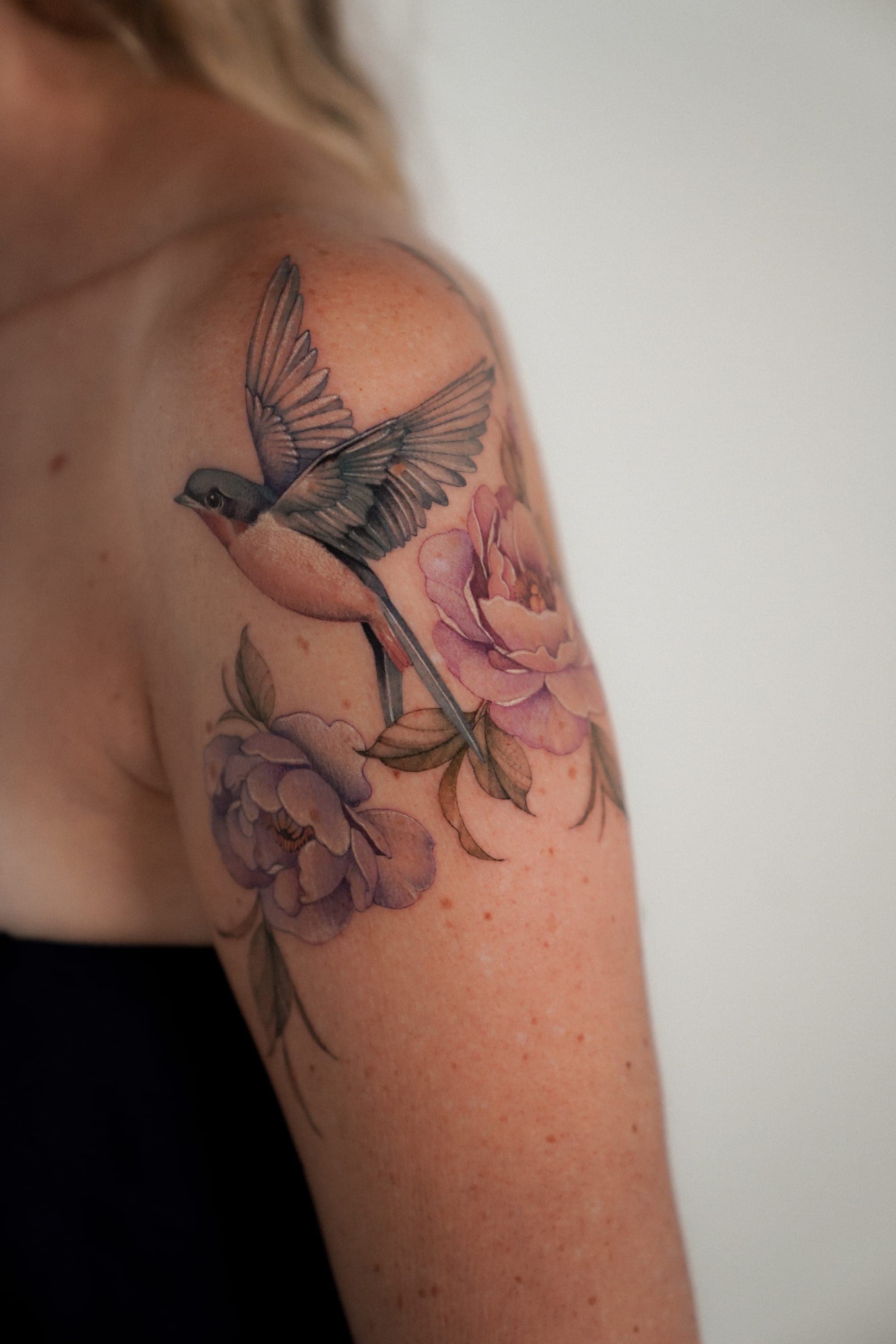 Swallow bird with peony flowers shoulder tattoo