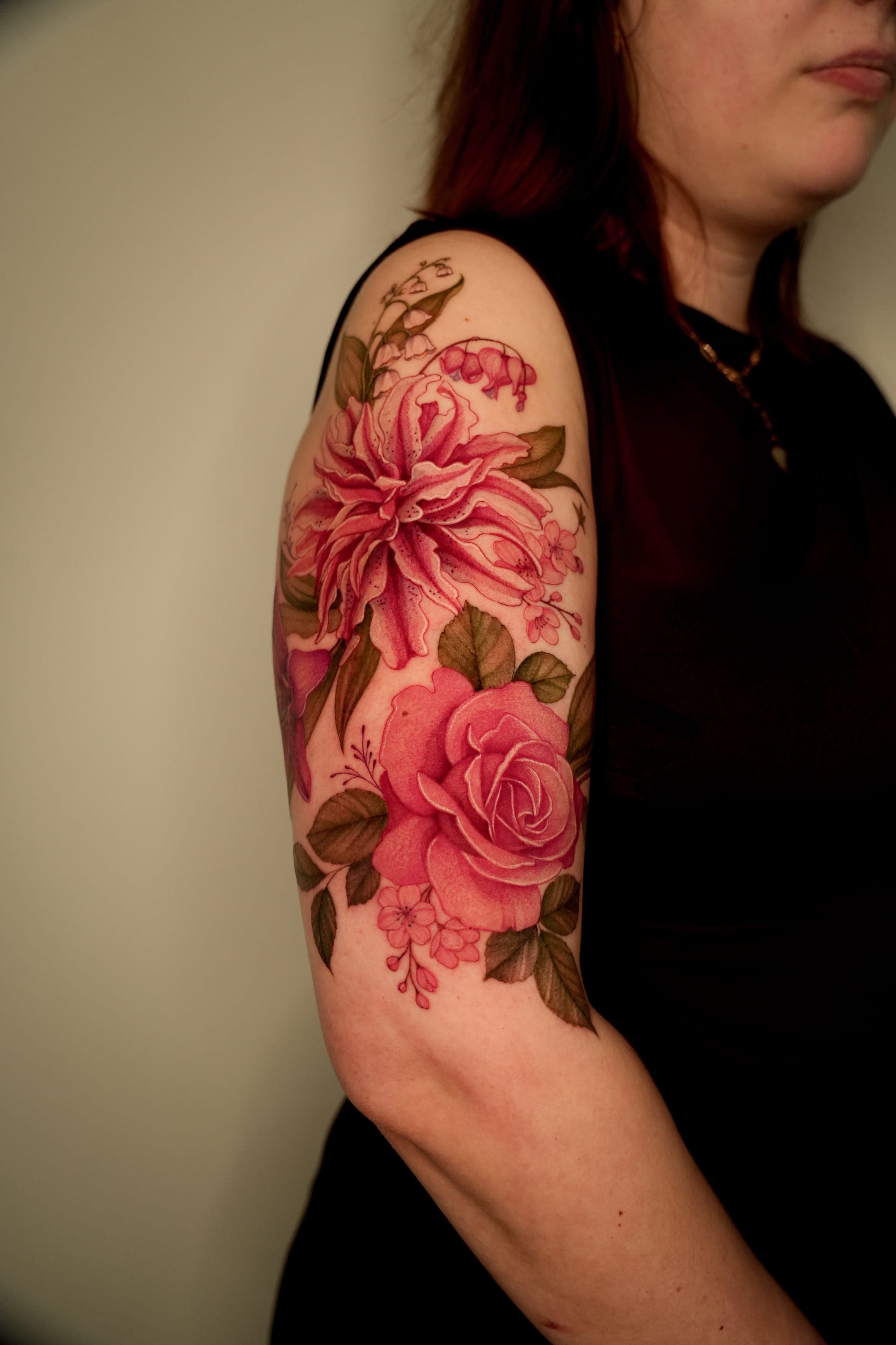 Pink dahlia, rose and lily of the valley shoulder tattoo